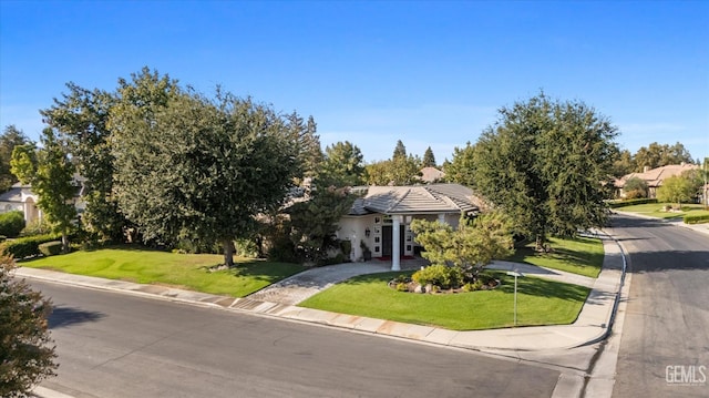 view of property hidden behind natural elements with a front yard