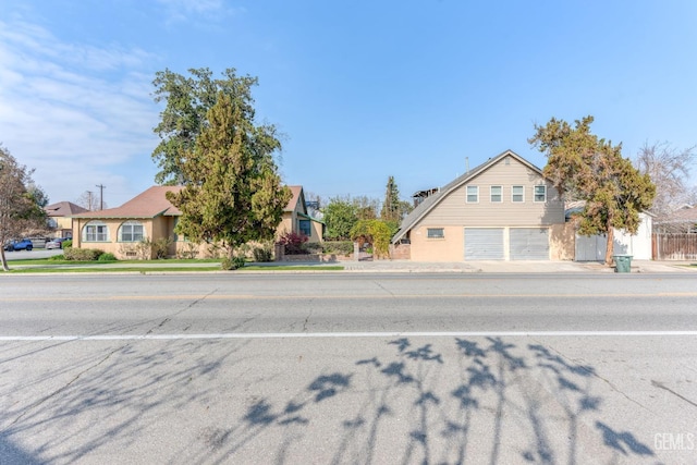 view of front of house with a residential view and concrete driveway