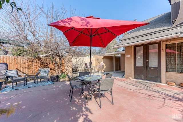 view of patio featuring french doors and fence