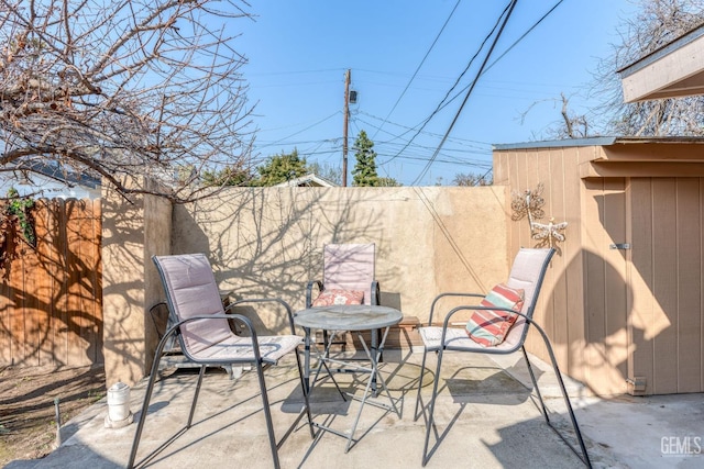 view of patio featuring a fenced backyard and a shed