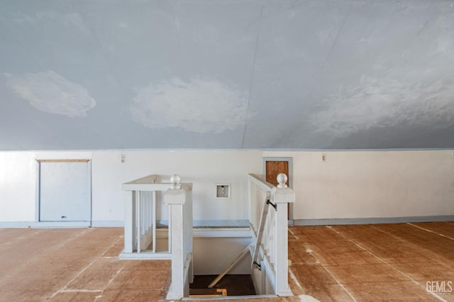 stairs with vaulted ceiling