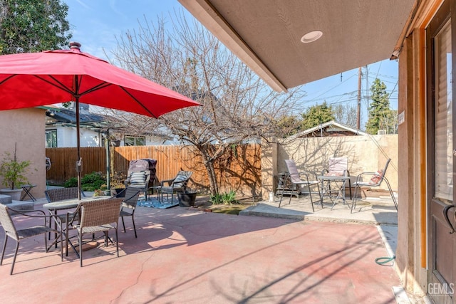 view of patio with a fenced backyard and outdoor dining area