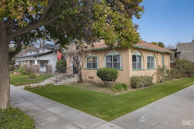 view of front of property featuring a front yard and stucco siding