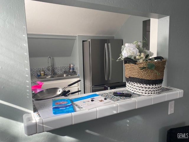 interior details featuring a sink and freestanding refrigerator