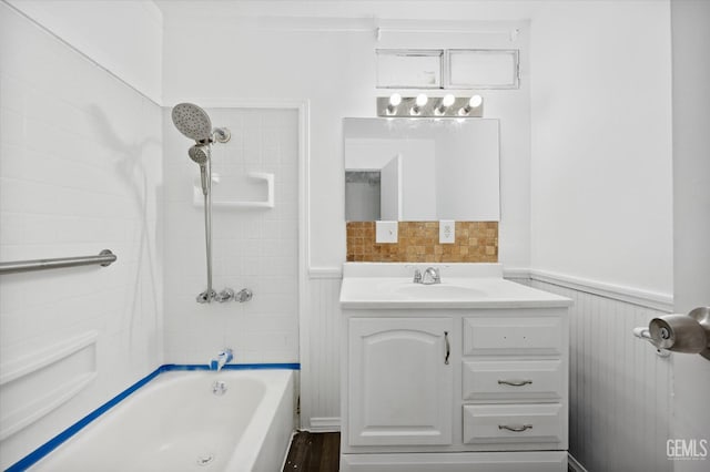 bathroom featuring vanity and tiled shower / bath