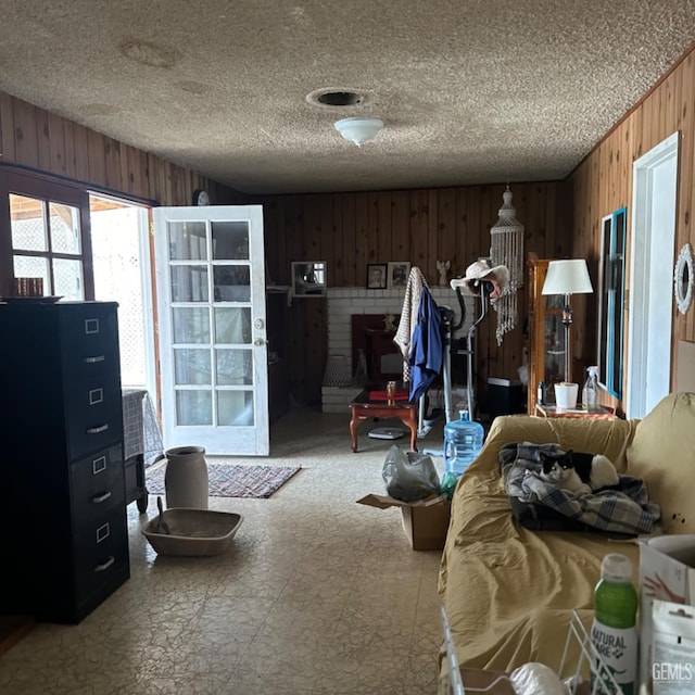 miscellaneous room with a fireplace and wooden walls