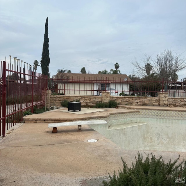 exterior space featuring a patio and an empty pool