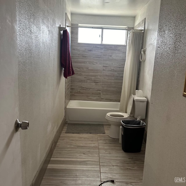 bathroom with shower / bath combo and toilet