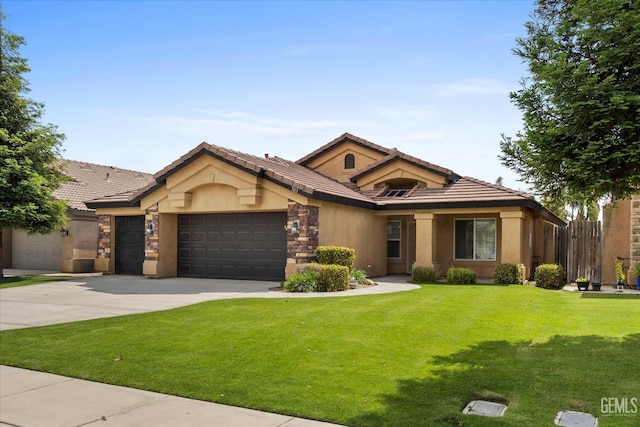 view of front of home featuring a tiled roof, a front yard, a garage, concrete driveway, and stucco siding