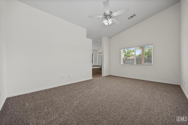 unfurnished room with baseboards, visible vents, carpet, and high vaulted ceiling