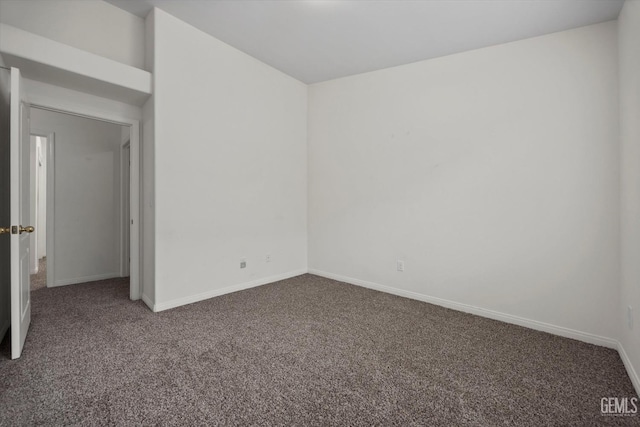 carpeted empty room with baseboards