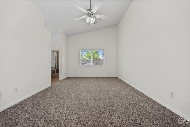 empty room featuring carpet floors, a ceiling fan, baseboards, and vaulted ceiling