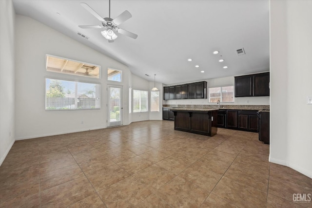 kitchen with a center island, a ceiling fan, open floor plan, and visible vents