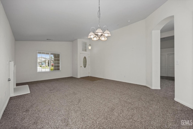 unfurnished room featuring an inviting chandelier, arched walkways, carpet, and lofted ceiling