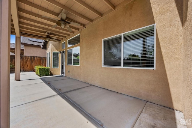 view of patio / terrace with ceiling fan and fence