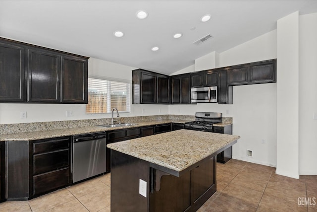 kitchen with a sink, visible vents, a center island, stainless steel appliances, and vaulted ceiling