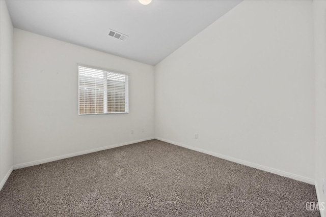 unfurnished room featuring baseboards, carpet, lofted ceiling, and visible vents