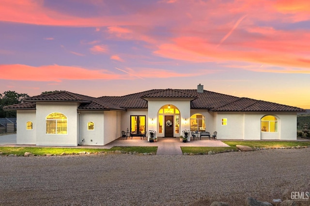 mediterranean / spanish-style house featuring a patio area