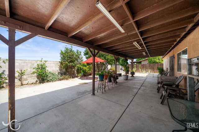 408 Isla Bonita St, Bakersfield, CA 93307 - fenced backyard with a patio area