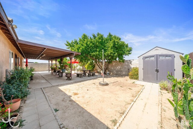 408 Isla Bonita St, Bakersfield, CA 93307 - fenced backyard with a patio area and a storage shed