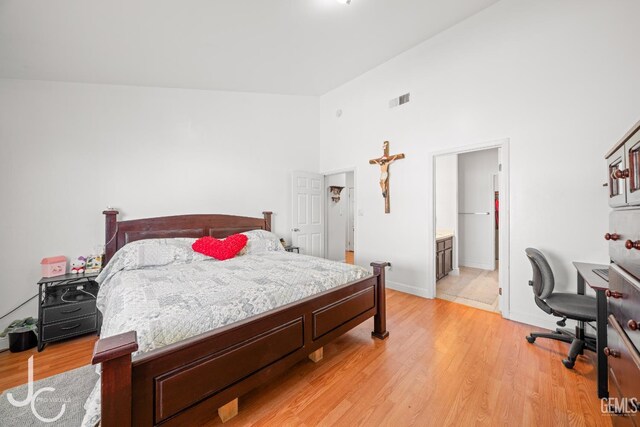 408 Isla Bonita St, Bakersfield, CA 93307 - bedroom with light wood-style floors, high vaulted ceiling, and ensuite bath