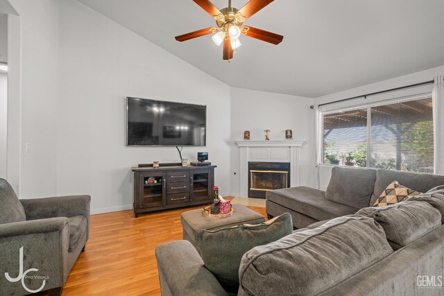 408 Isla Bonita St, Bakersfield, CA 93307 - living room featuring vaulted ceiling, a ceiling fan, light wood finished floors, and a fireplace with flush hearth