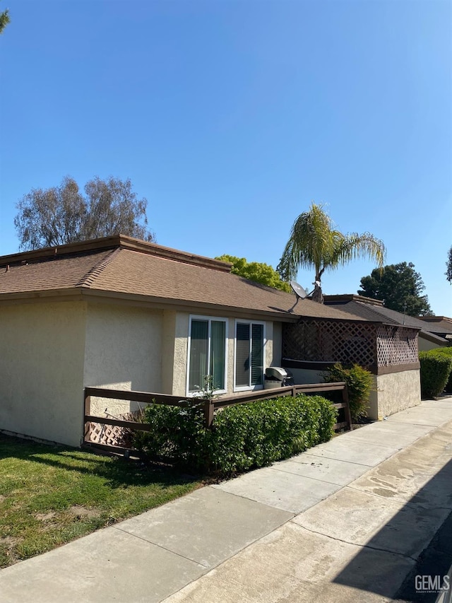 view of side of home featuring a lawn