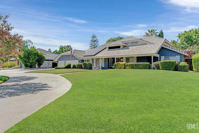 11520 Pinehaven Ave, Bakersfield, CA 93312 - view of front of home featuring solar panels, covered porch, a front yard, a tiled roof, and curved driveway