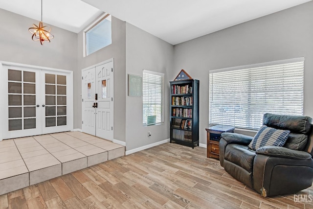 11520 Pinehaven Ave, Bakersfield, CA 93312 - entrance foyer with wood finished floors, french doors, baseboards, a towering ceiling, and a chandelier