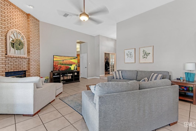 11520 Pinehaven Ave, Bakersfield, CA 93312 - living room featuring light tile patterned floors, a ceiling fan, a brick fireplace, and a towering ceiling