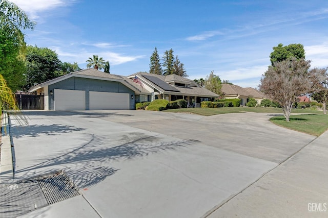 11520 Pinehaven Ave, Bakersfield, CA 93312 - view of front of house featuring concrete driveway, an attached garage, and roof mounted solar panels