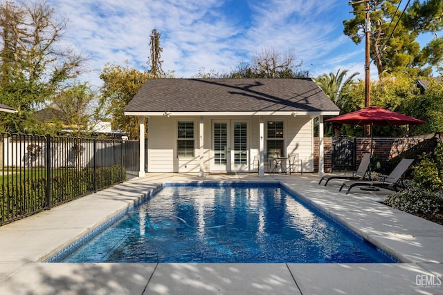 view of pool featuring fence, a patio area, a fenced in pool, and french doors