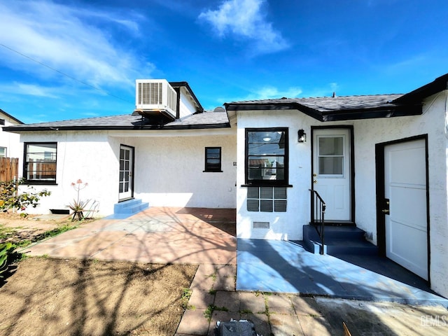 209 Bedford Way, Bakersfield, CA 93308 - rear view of property with stucco siding, entry steps, a patio, cooling unit, and a shingled roof