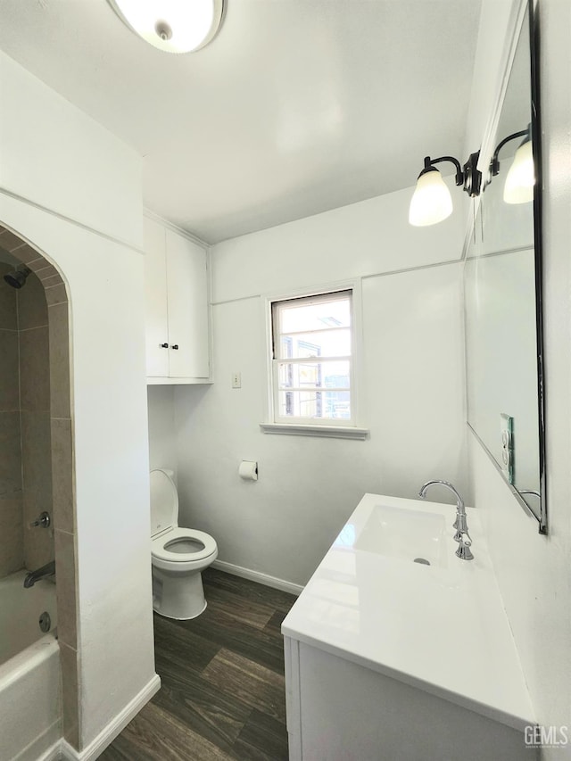 209 Bedford Way, Bakersfield, CA 93308 - full bathroom with baseboards, toilet, bathing tub / shower combination, wood finished floors, and vanity