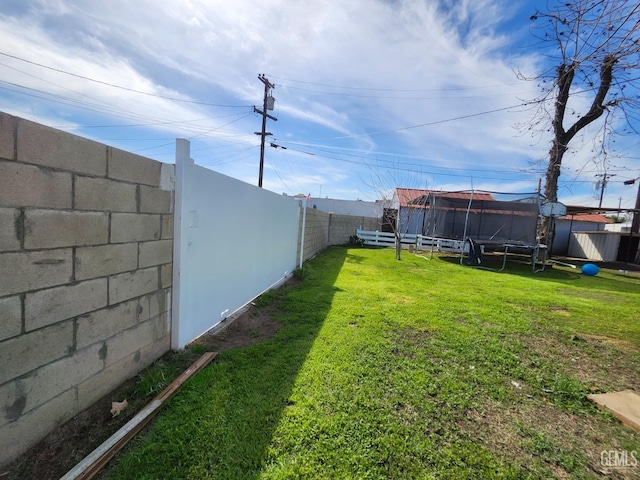 209 Bedford Way, Bakersfield, CA 93308 - view of yard with a trampoline and a fenced backyard