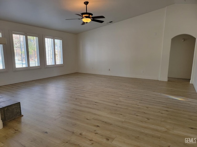 unfurnished room with ceiling fan, lofted ceiling, and light hardwood / wood-style flooring