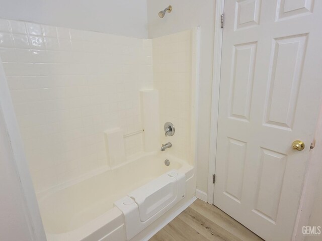 bathroom with wood-type flooring and bathtub / shower combination