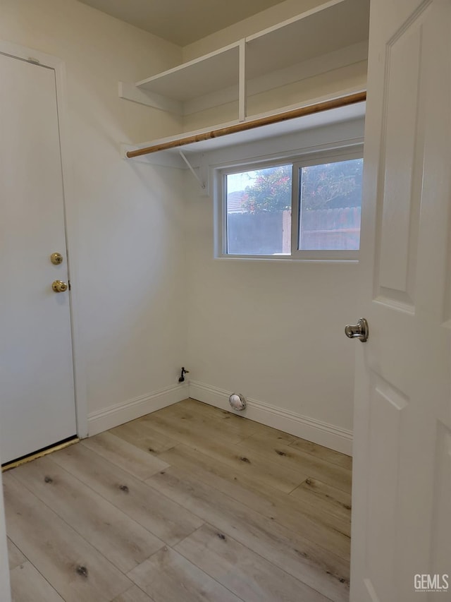 laundry area featuring light wood-type flooring