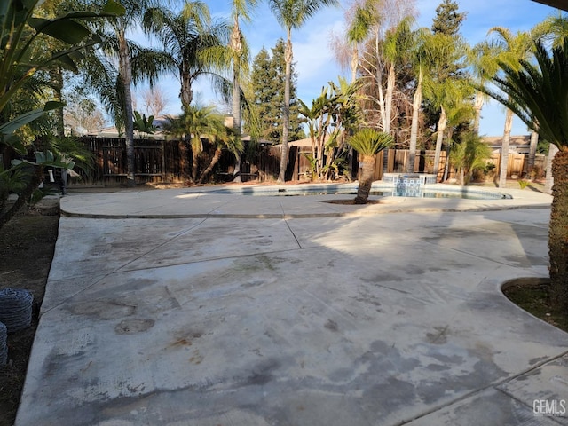 view of patio / terrace with a fenced in pool