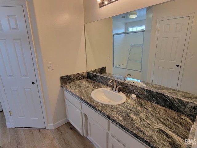 bathroom featuring hardwood / wood-style flooring and vanity