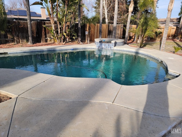 view of pool featuring an in ground hot tub