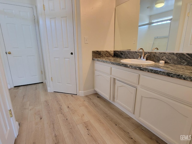 bathroom with hardwood / wood-style flooring and vanity