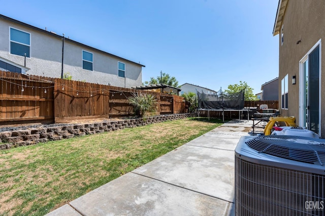 5906 Commonwealth Ave, Bakersfield, CA 93313 - fenced backyard featuring a trampoline and a patio