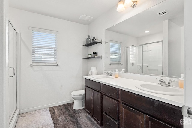 5906 Commonwealth Ave, Bakersfield, CA 93313 - bathroom featuring a shower stall, double vanity, and wood finished floors