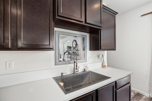 5906 Commonwealth Ave, Bakersfield, CA 93313 - kitchen featuring dark brown cabinetry and light countertops