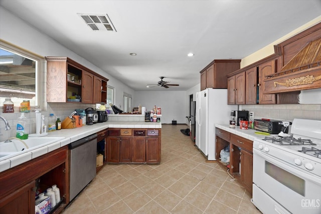 2716 Bladen St, Bakersfield, CA 93309 - kitchen with white gas stove, dishwasher, open shelves, a peninsula, and decorative backsplash