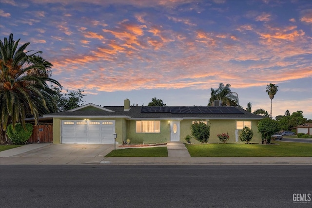 2716 Bladen St, Bakersfield, CA 93309 - ranch-style house featuring concrete driveway, a garage, solar panels, and stucco siding