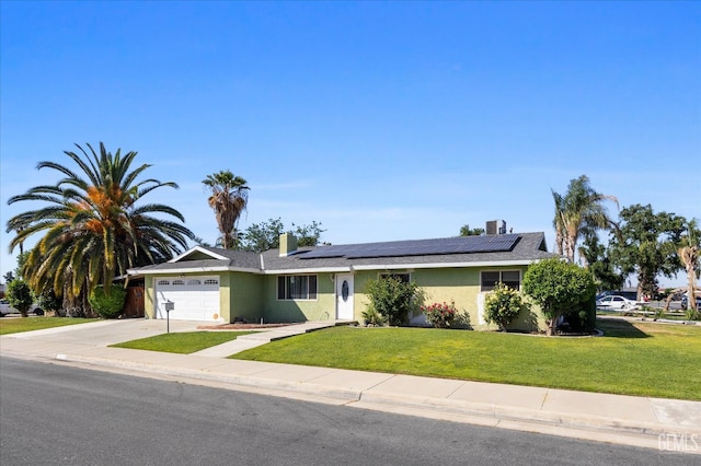2716 Bladen St, Bakersfield, CA 93309 - ranch-style house featuring driveway, an attached garage, a front yard, roof mounted solar panels, and stucco siding