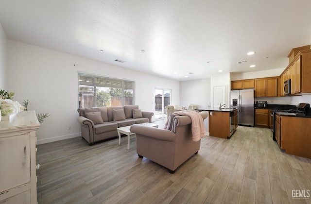 5812 Turquoise Ridge Dr, Bakersfield, CA 93313 - living area with light wood-style floors and recessed lighting