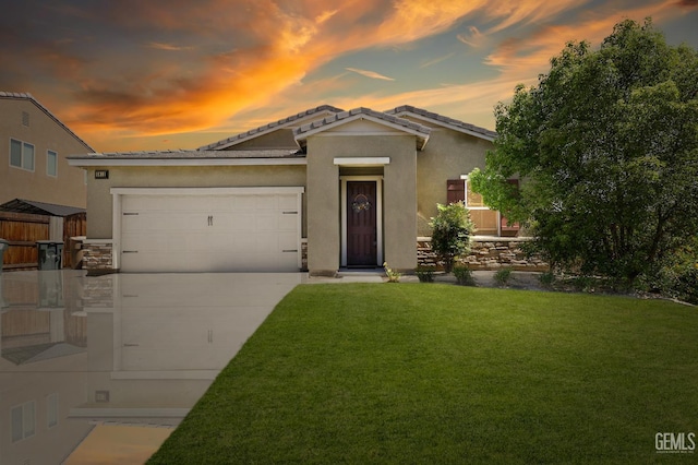 5812 Turquoise Ridge Dr, Bakersfield, CA 93313 - view of front facade featuring a lawn, concrete driveway, stucco siding, an attached garage, and a tiled roof